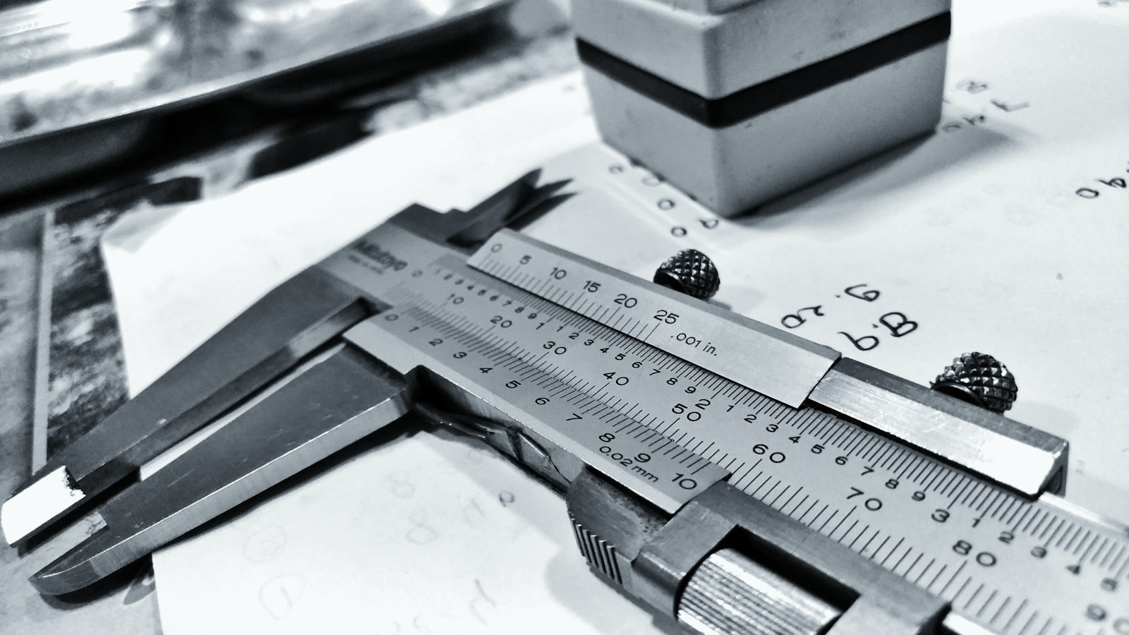 Caliper checking a part against an engineering drawing